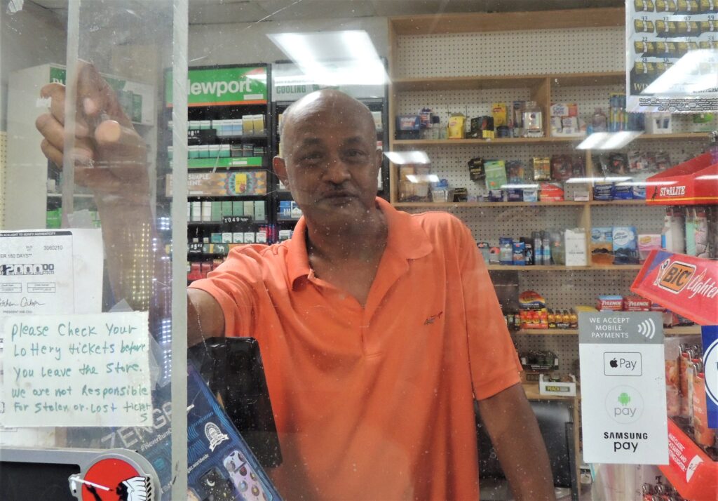 Convenience store owner Branu Woldegebriel said he spends more on lottery tickets than he wins, just like his customers. (Credit: Jill Jordan Sieder)