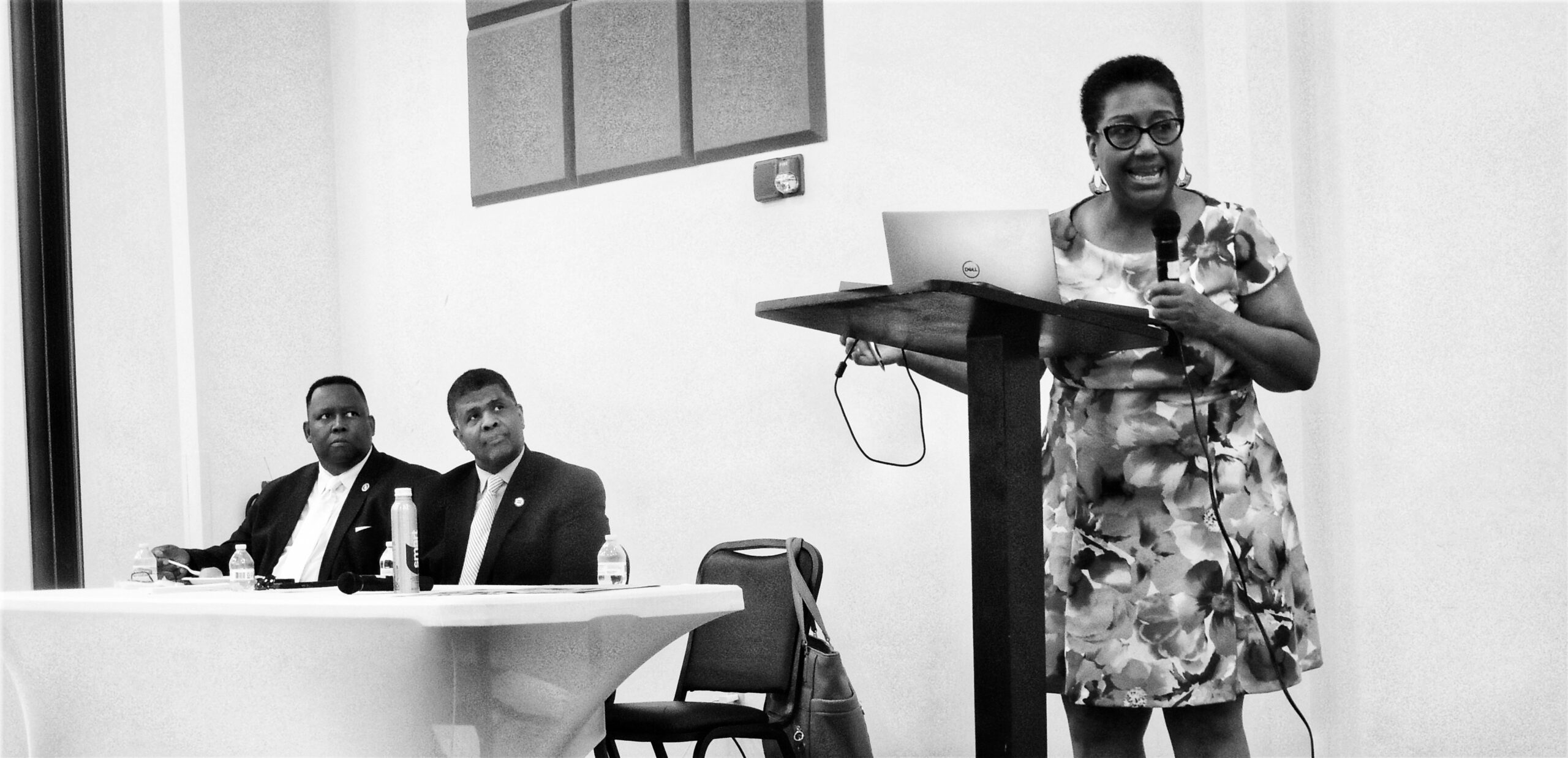 GLBC Chair Carl Gilliard and John Moye, policy and legislative affairs director of the Urban League of Greater Atlanta (ULGA) listen as Nancy Flake Johnson, president and CEO of ULGA, presents “The State of Black Georgia” report to Black legislators and civic leaders in Savannah on July 21, 2023. (Credit: Jill Jordan Sieder).