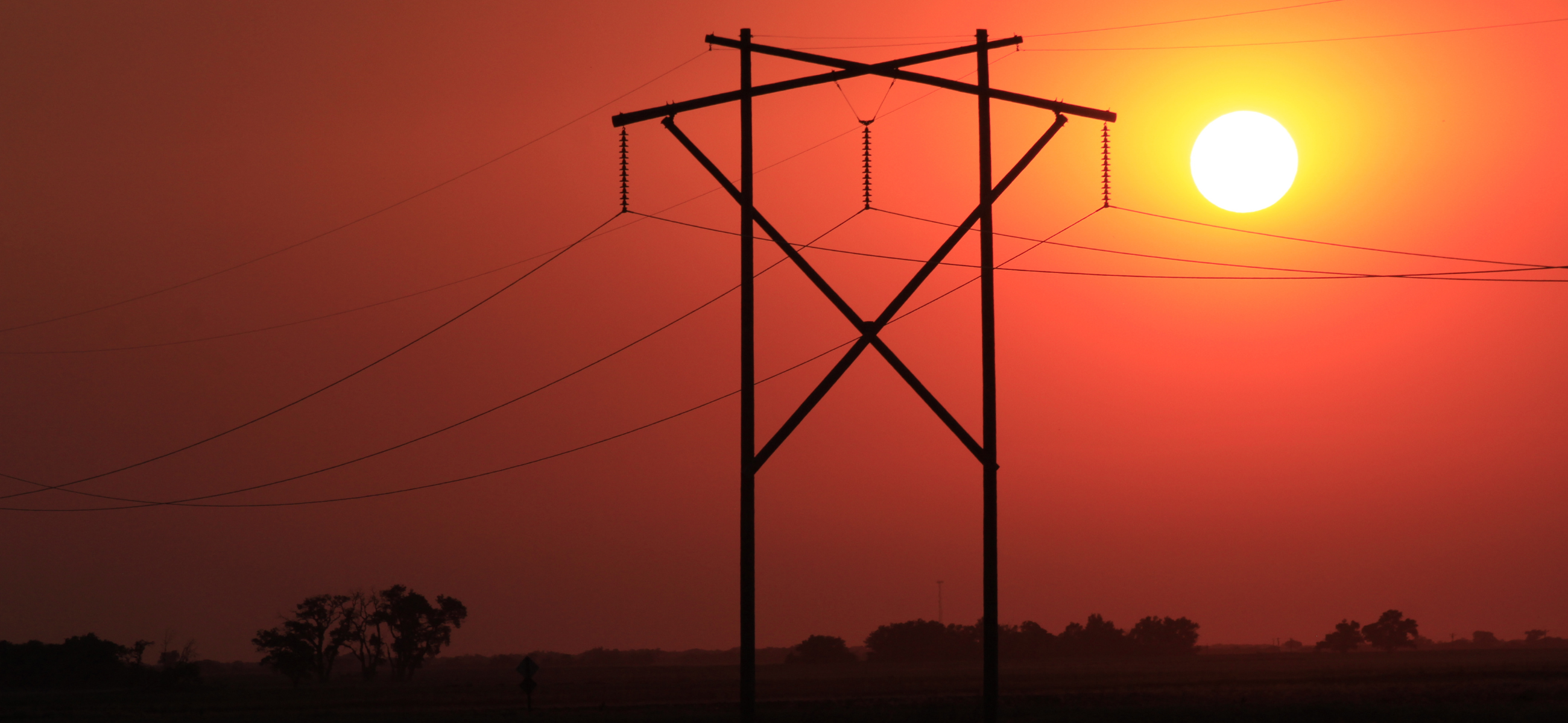 Power lines against red sunset in Nickerson, Kansas.