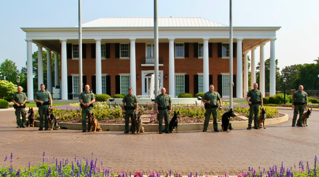 The eight K-9 teams comprising the DNR K-9 unit at the Governor’s Mansion on June 7, 2023, after a K-9 graduation ceremony.(Credit: Georgia Department of Natural Resources)