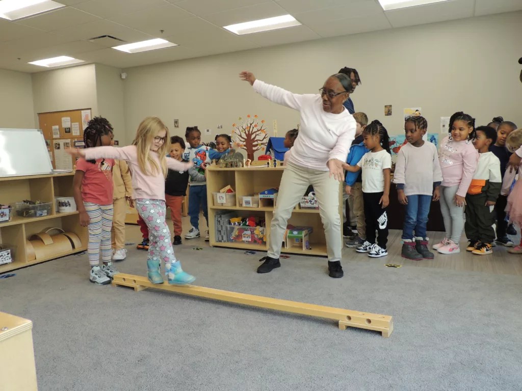 Lead teacher Juanita Willis leads pre-K students in a physical activity at the Barack and Michelle Obama Center in south Atlanta.