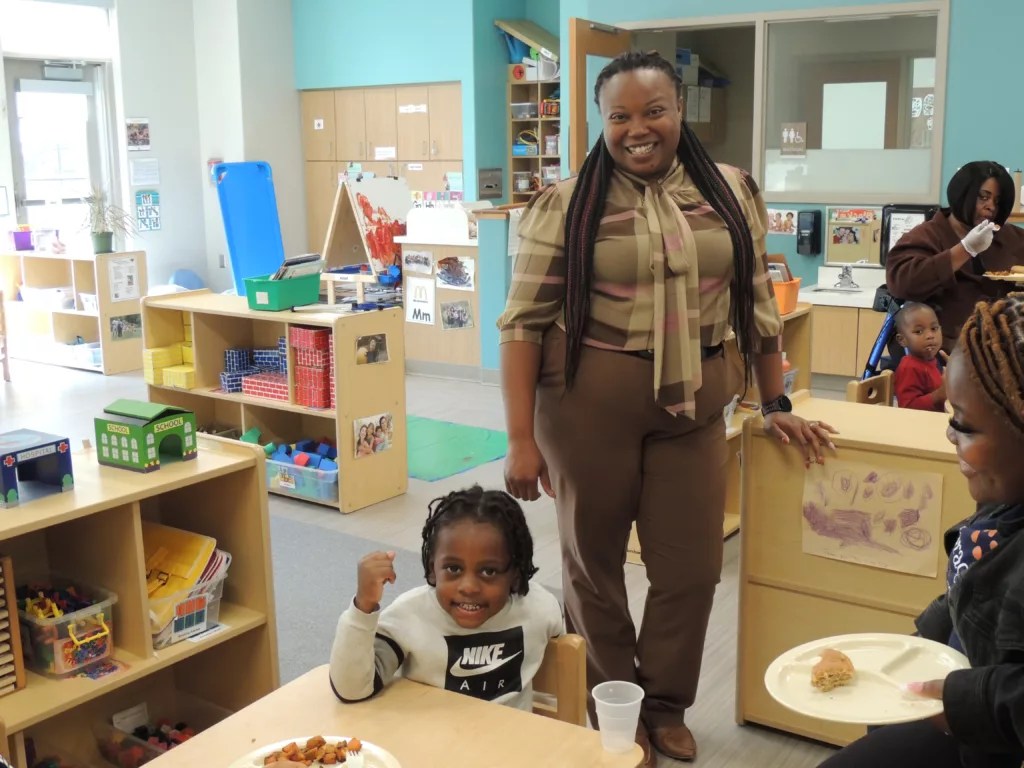 Loni Smith, director of the Barack and Michelle Obama Center in south Atlanta, with a preschool student.