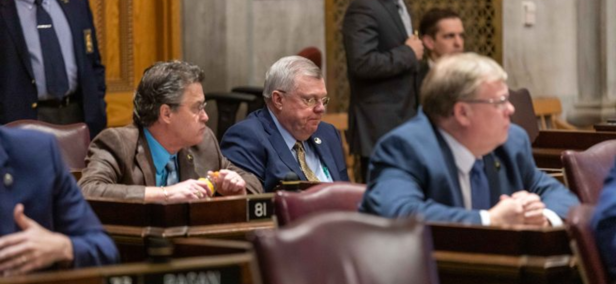 Rep. Curtis Johnson (R-Clarksville), seated, center, attends a House floor session in Nashville. At left is Rep. John Holsclaw (R-Elizabethton) and Tim Rudd (R-Murfreesboro) is to the right. (Erik Schelzig, Tennessee Journal)