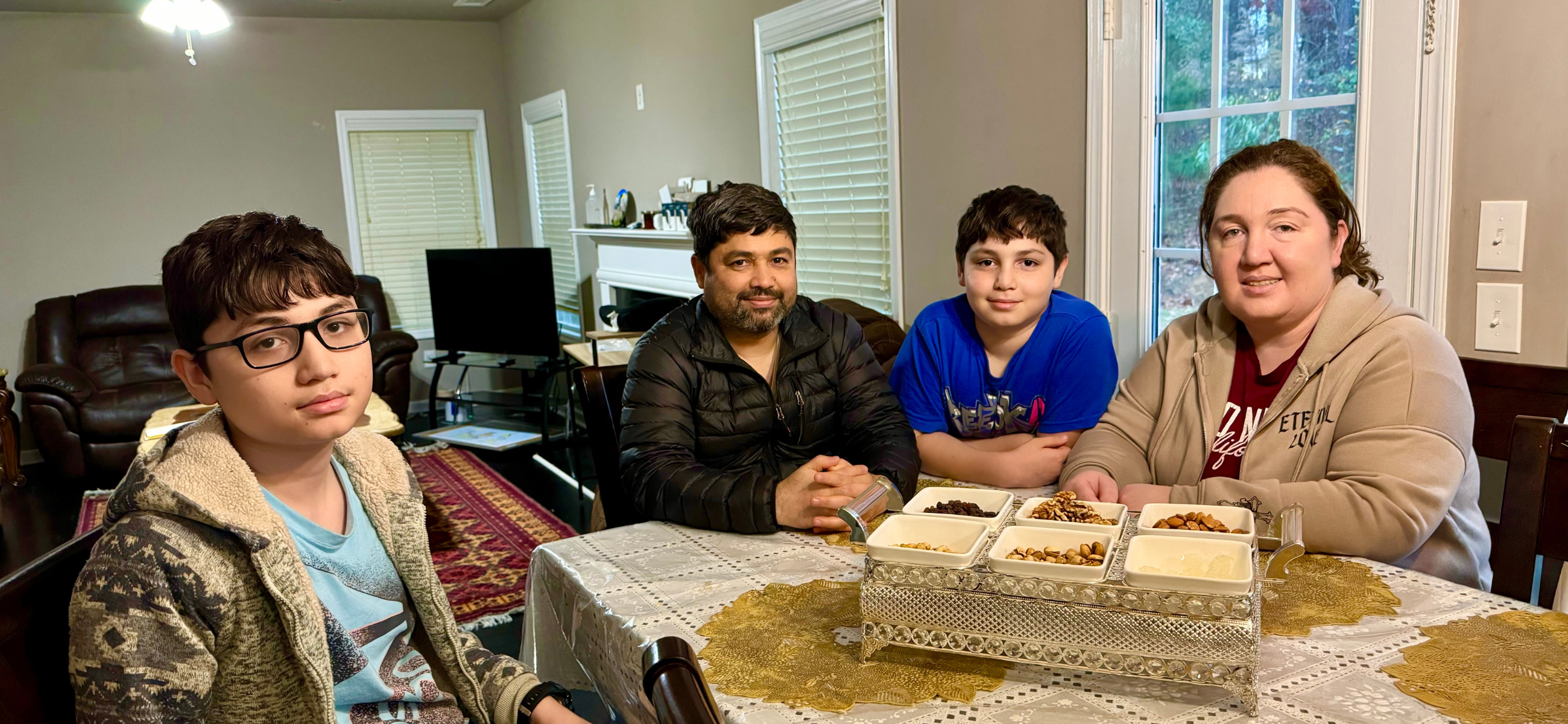 Farangais Saidi (right) and her husband Sayed Sajjad (center left) at their home in Snellville with their two sons, Harakhsh Sajjad (left) and Hoshang Sajjad (center right). Saidi, an OB/GYN doctor trained in Afghanistan, hopes to practice medicine in Georgia. Sajjad, an orthopedist, said the family can only afford for one of them to pursue medical licensing in Georgia at present. Both doctors are currently working as pharmacy technicians.