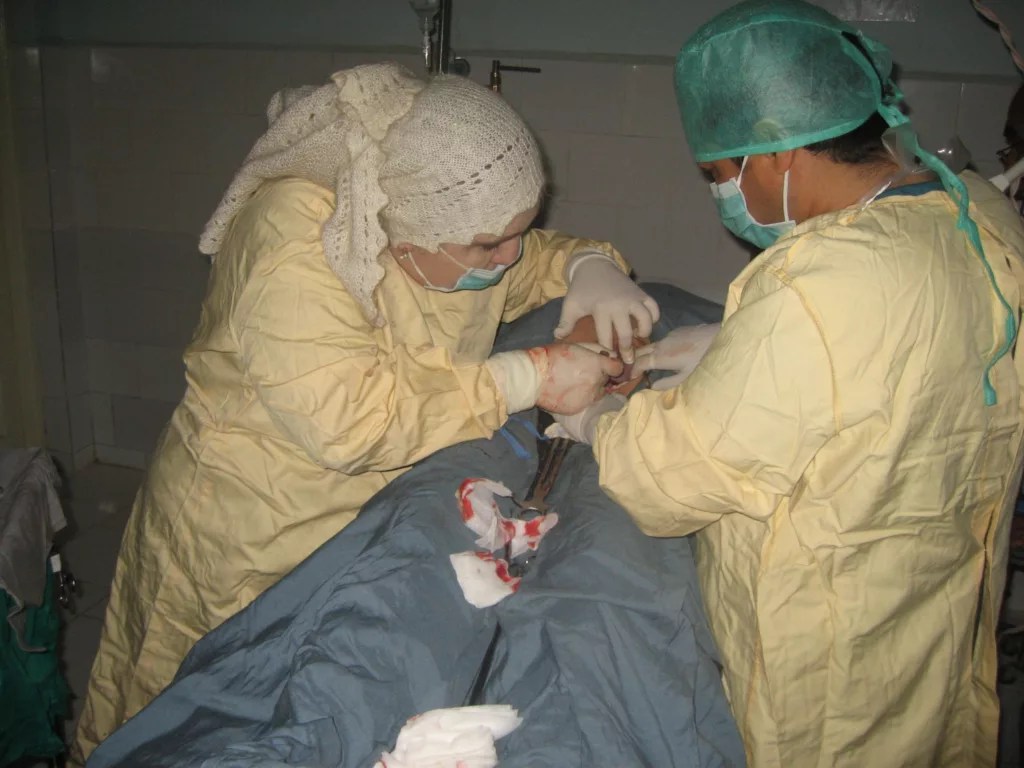 Afghani obstetrician Farangais Saidi (left) performs a Caesarian section surgery in Yawan City in rural Afghanistan in 2011, assisted by her husband Sayed Sajjad. Saidi said she delivered about 9,000 babies before coming to the U.S..