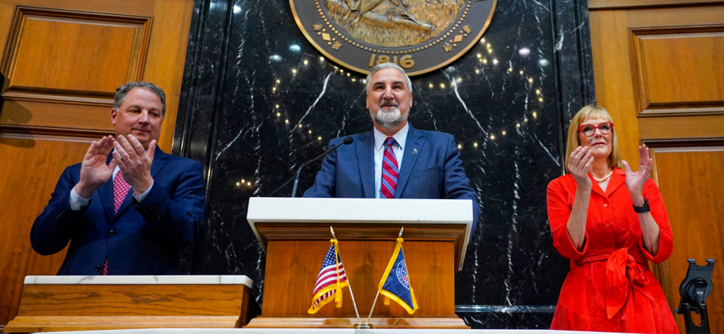 Indiana Gov. Eric Holcomb, center, is joined by Speaker of the House Todd Huston, left, and Lt. Gov. Suzanne Crouch as he is introduced before delivering his State of the State address to a joint session of the legislature at the Statehouse, Tuesday, Jan. 9, 2024, in Indianapolis. (AP Photo/Darron Cummings)