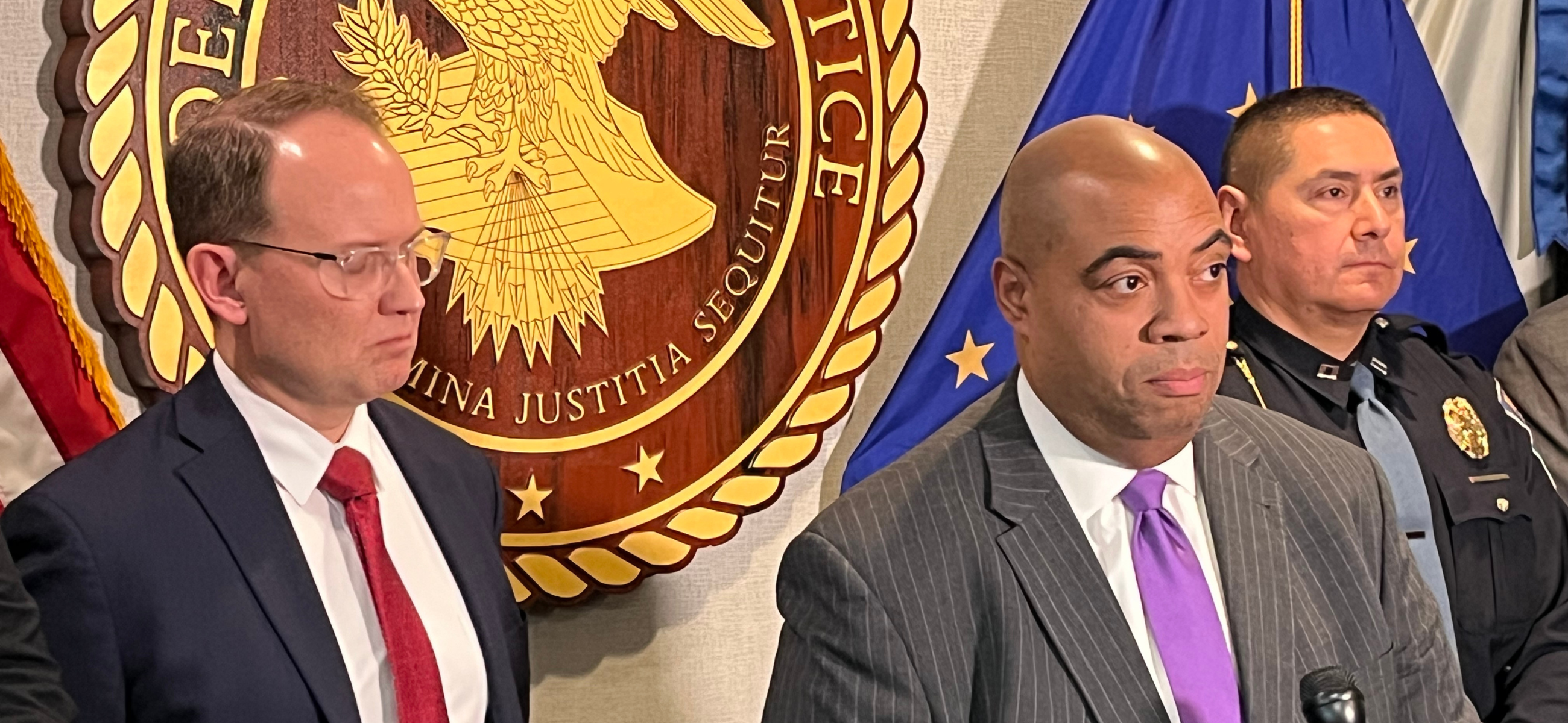 U.S. Attorney Zachary Myers, center, speaks alongside FBI Indianapolis Special Agent in Charge Herb Stapleton, left, and state police Capt. Ron Galaviz during a news conference about criminal charges against leaders of a now-closed online school on Thursday, Jan. 25, 2024. (Credit: Tom Davies)