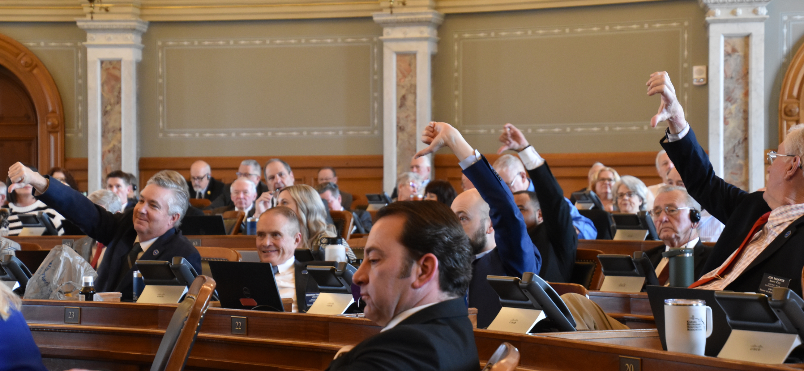 Representatives put their thumbs down to signal changing their votes to no Feb. 22, 2024, on the House floor.