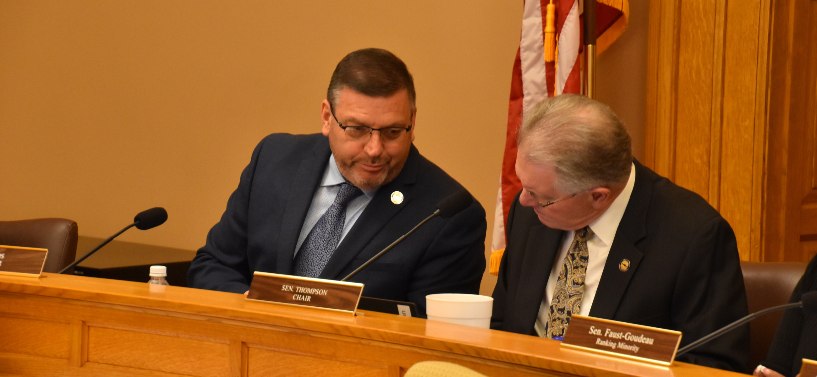 Sen. Rick Kloos, left, talks to Sen. Jeff Thompson during a Feb. 7, 2024, meeting of the Federal and State Affairs Committee.