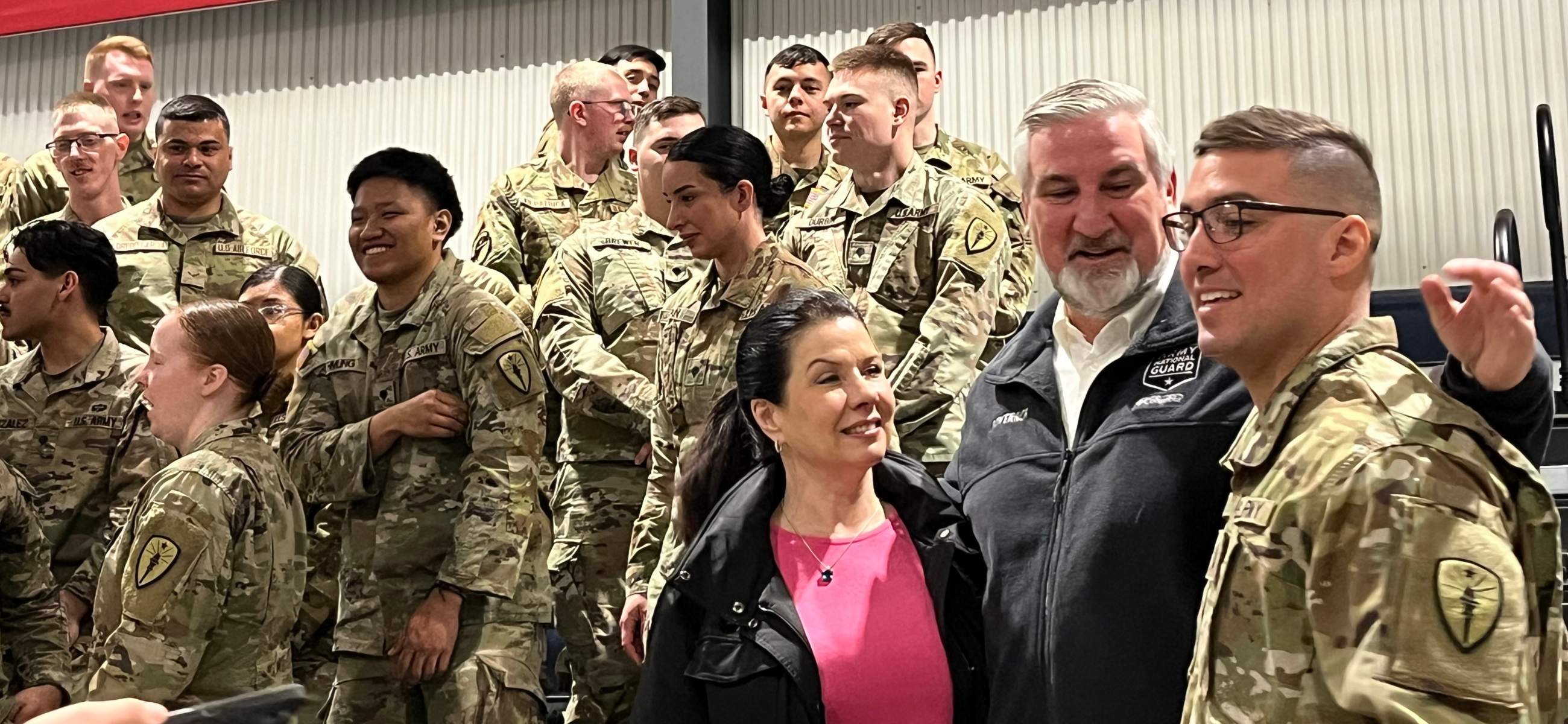 Gov. Eric Holcomb and first lady Janet Holcomb speak with an Indiana National Guard soldier after a departure ceremony at Camp Atterbury for about 50 Guard members going on a mobilization to the U.S.-Mexican border in Texas on Thursday, March 28, 2024. (Credit: Tom Davies)