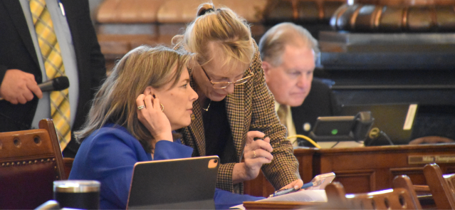 Sens. Kellie Warren, left, and Elaine Bowers talk March 26, 2024, on the Senate floor.