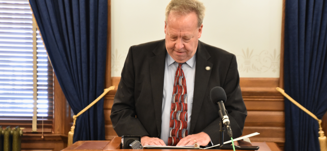 Sen. Tom Holland outlines his property tax cut plan at a press conference June 12.