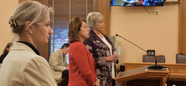 Jane Brown, plan president for Aetna Better Health of Kansas, watches as KDHE Secretary Janet Stanek and Medicaid Director Christine Osterlund speak to the Bethel Committee on June 24.